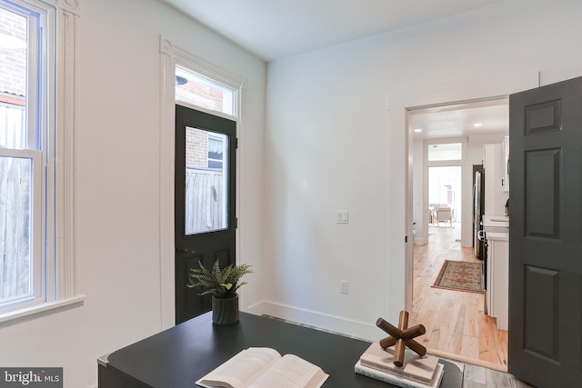entryway featuring baseboards, recessed lighting, and light wood-style flooring