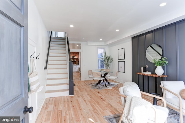 entrance foyer featuring light wood-type flooring, baseboards, recessed lighting, and stairway