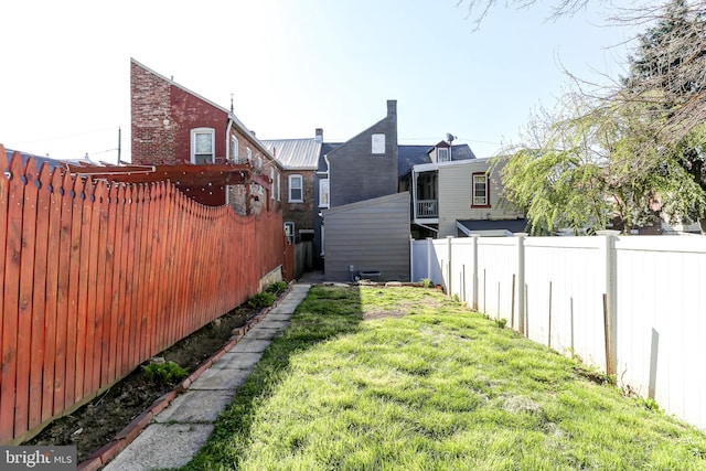 view of yard with a fenced backyard
