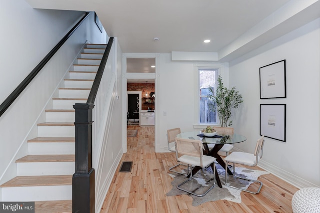dining space with stairway, light wood-type flooring, baseboards, visible vents, and recessed lighting