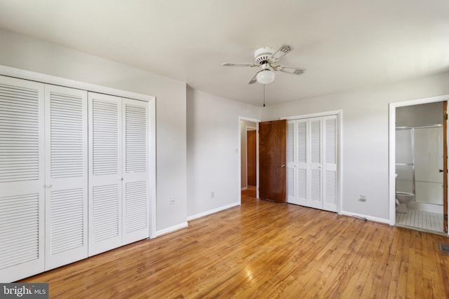 8601 Pretoria Ct, Clinton, MD 20735 - unfurnished bedroom featuring ensuite bathroom, two closets, ceiling fan, light wood finished floors, and baseboards