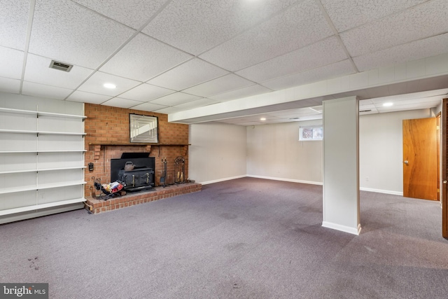 8601 Pretoria Ct, Clinton, MD 20735 - interior space featuring a drop ceiling, a wood stove, visible vents, baseboards, and carpet flooring