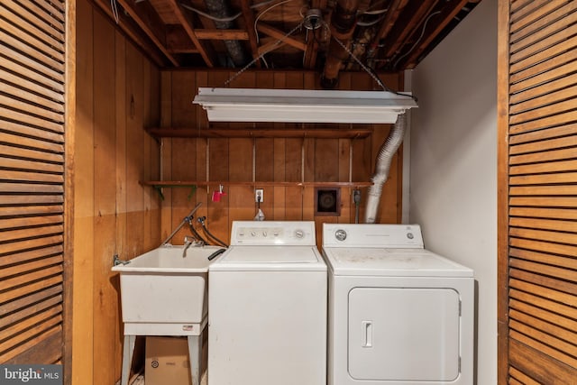 8601 Pretoria Ct, Clinton, MD 20735 - washroom featuring wooden walls, washer and clothes dryer, laundry area, and a sink