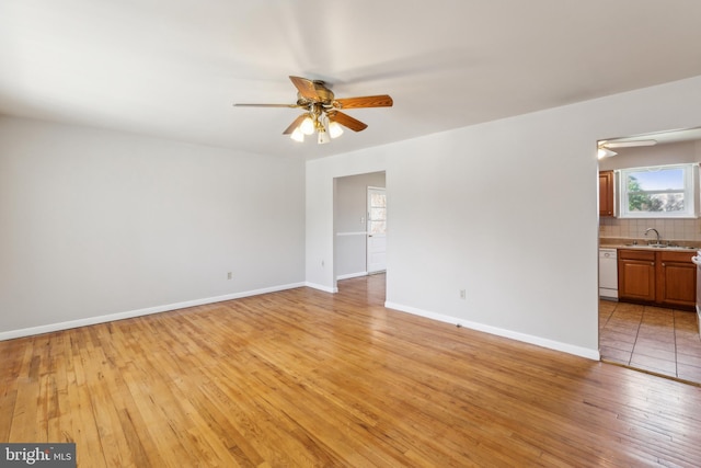 8601 Pretoria Ct, Clinton, MD 20735 - empty room featuring light wood finished floors, a ceiling fan, baseboards, and a sink