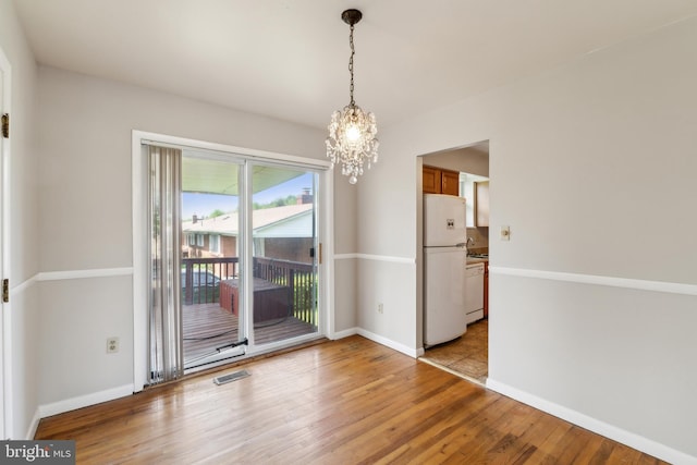 8601 Pretoria Ct, Clinton, MD 20735 - unfurnished dining area with visible vents, light wood finished floors, baseboards, and a notable chandelier
