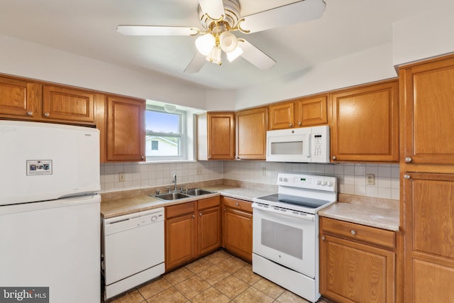 8601 Pretoria Ct, Clinton, MD 20735 - kitchen featuring a sink, brown cabinetry, decorative backsplash, white appliances, and light countertops