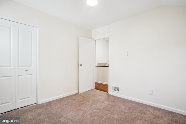 2305 Houston St, Suitland, MD 20746 - unfurnished bedroom with carpet floors, a closet, and lofted ceiling