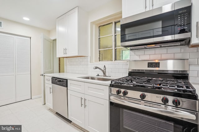 2305 Houston St, Suitland, MD 20746 - kitchen with appliances with stainless steel finishes, white cabinetry, backsplash, and recessed lighting