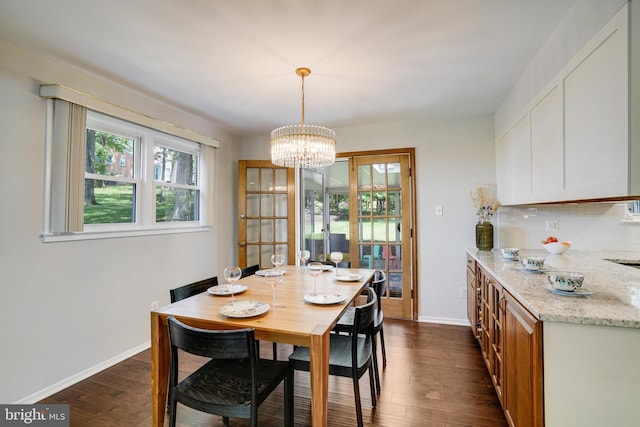 4705 Exeter St, Annandale, VA 22003 - dining room featuring dark wood-style floors, a chandelier, and baseboards