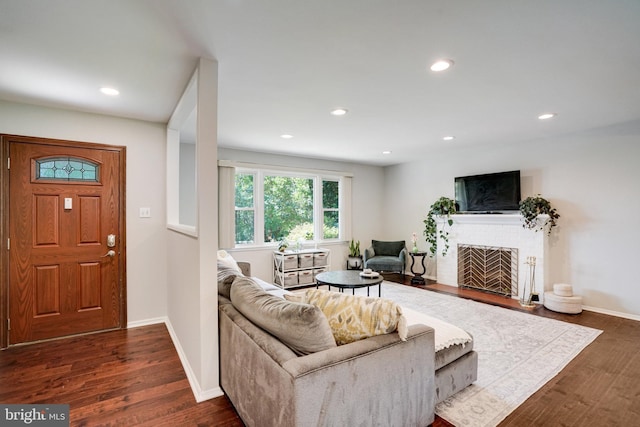 4705 Exeter St, Annandale, VA 22003 - living room with dark wood-type flooring, a brick fireplace, recessed lighting, and baseboards