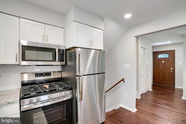 4705 Exeter St, Annandale, VA 22003 - kitchen featuring appliances with stainless steel finishes, dark wood finished floors, baseboards, white cabinetry, and recessed lighting