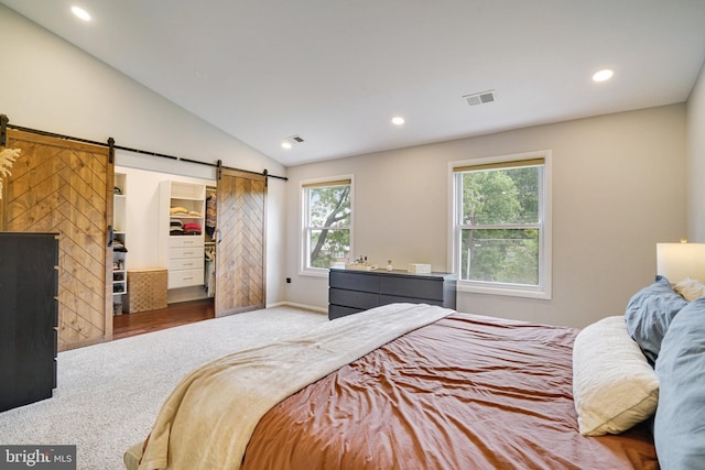 4705 Exeter St, Annandale, VA 22003 - bedroom with a barn door, carpet floors, multiple windows, vaulted ceiling, and recessed lighting