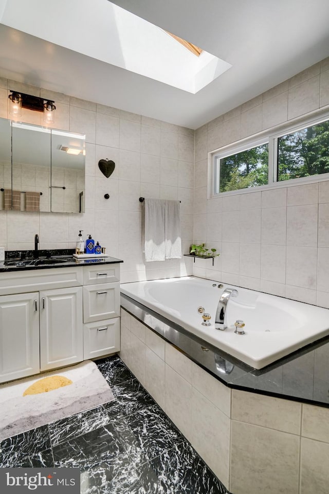 4705 Exeter St, Annandale, VA 22003 - full bathroom featuring vanity, a bath, a skylight, tile walls, and marble tiled flooring