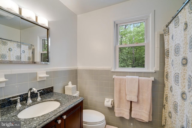 4705 Exeter St, Annandale, VA 22003 - bathroom with tile walls, toilet, vanity, a wainscoted wall, and a shower with shower curtain