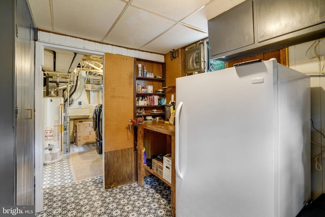 4705 Exeter St, Annandale, VA 22003 - below grade area with freestanding refrigerator, gas water heater, and tile patterned floors