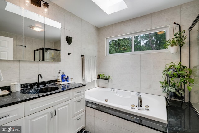 4705 Exeter St, Annandale, VA 22003 - bathroom with tile walls, a skylight, vanity, a jetted tub, and tiled shower