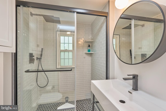 bathroom featuring tile patterned floors, a shower stall, and vanity