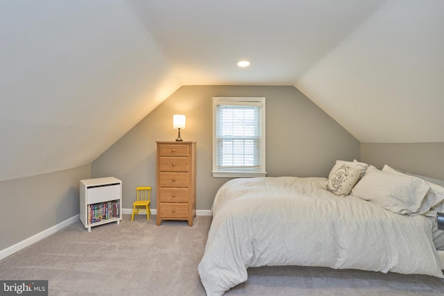 bedroom featuring carpet floors, baseboards, and vaulted ceiling