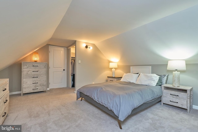 bedroom with light carpet and lofted ceiling