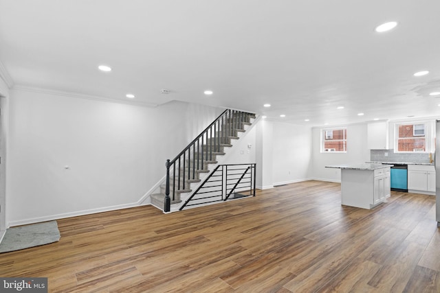 interior space featuring light wood-style flooring, stairway, recessed lighting, and baseboards