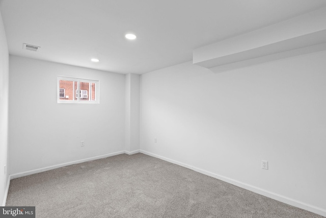 basement featuring baseboards, carpet, visible vents, and recessed lighting