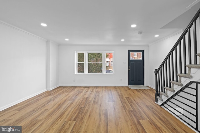 entryway with stairway, light wood-type flooring, and crown molding