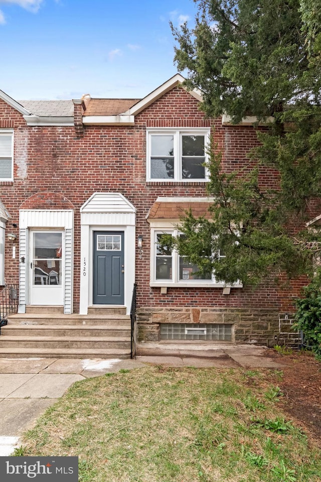view of property featuring brick siding