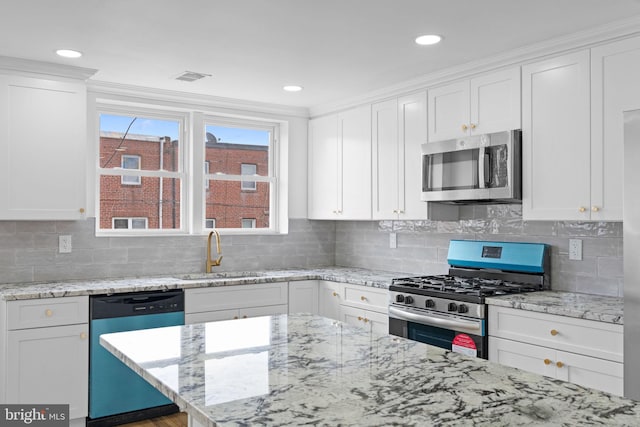 kitchen with a sink, white cabinetry, and stainless steel appliances