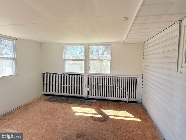 empty room featuring wood walls
