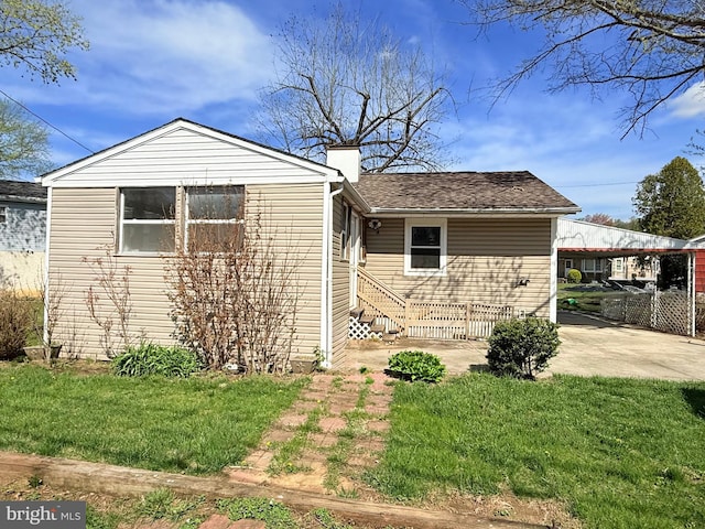 view of front of house with a front lawn, a chimney, and entry steps