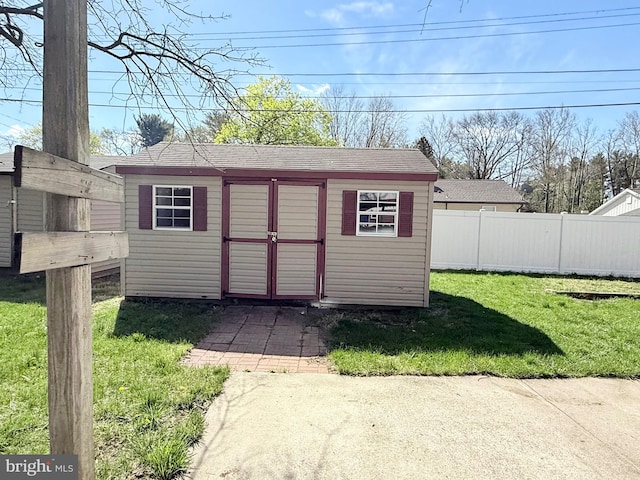 view of shed featuring fence