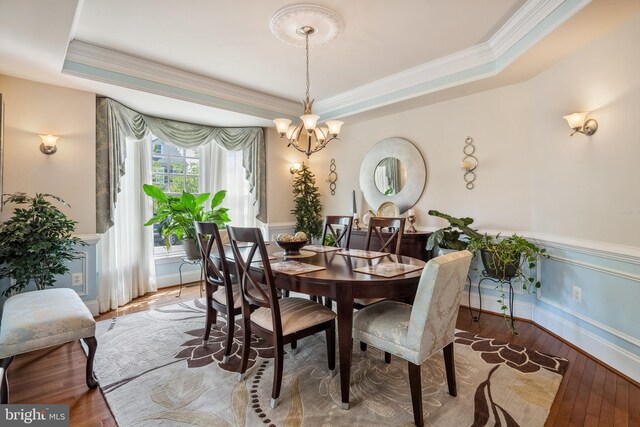 3716 Taft Ave, Alexandria, VA 22304 - dining area with wood-type flooring, a chandelier, ornamental molding, and a raised ceiling