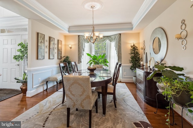 3716 Taft Ave, Alexandria, VA 22304 - dining area featuring a decorative wall, a notable chandelier, a raised ceiling, dark wood finished floors, and ornamental molding