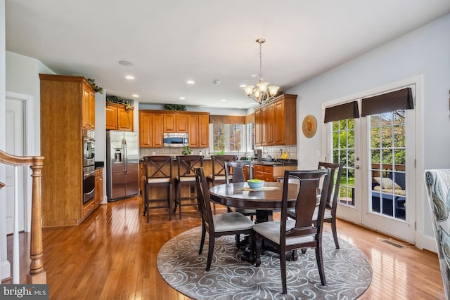 3716 Taft Ave, Alexandria, VA 22304 - dining room with a chandelier, a wealth of natural light, light wood finished floors, and visible vents