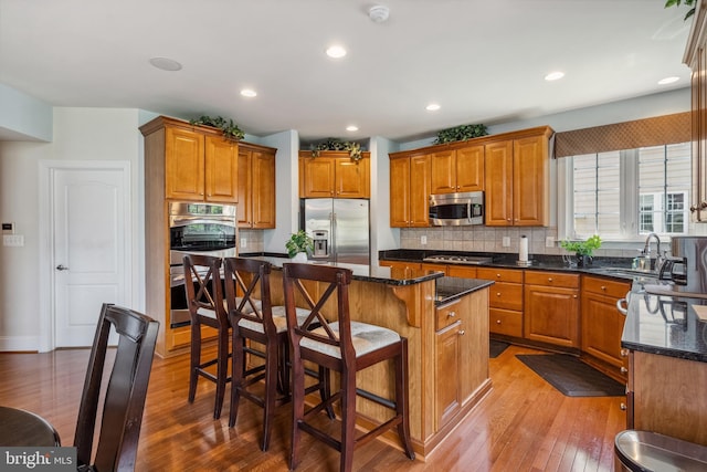 3716 Taft Ave, Alexandria, VA 22304 - kitchen with brown cabinets, appliances with stainless steel finishes, and light wood-type flooring