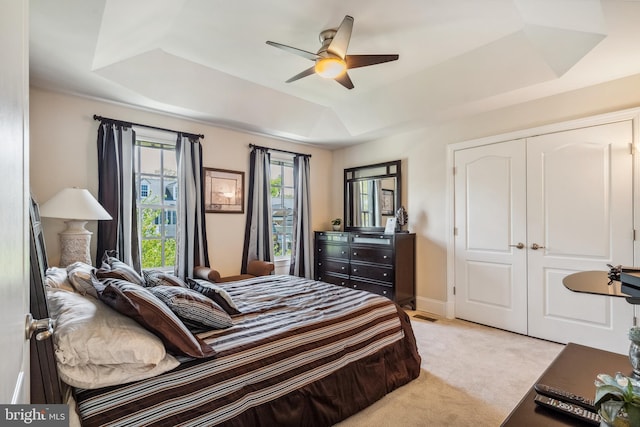 3716 Taft Ave, Alexandria, VA 22304 - bedroom featuring a ceiling fan, a closet, light carpet, a tray ceiling, and baseboards