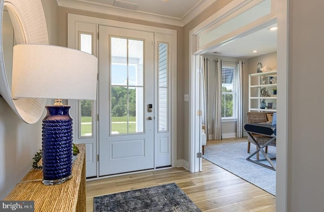 24020 Bark Wood Ct, Lewes, DE 19958 - entryway featuring visible vents, baseboards, wood finished floors, and ornamental molding