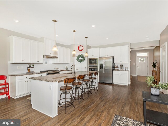 551 Timbermill Ct, Emmitsburg, MD 21727 - kitchen featuring a kitchen island with sink, dark wood-style flooring, white cabinetry, a breakfast bar, and appliances with stainless steel finishes