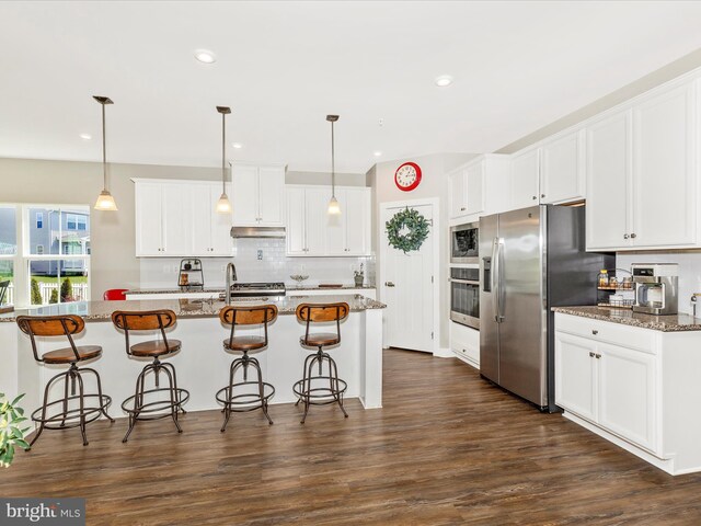 551 Timbermill Ct, Emmitsburg, MD 21727 - kitchen with white cabinets, dark wood-type flooring, decorative backsplash, appliances with stainless steel finishes, and a breakfast bar area