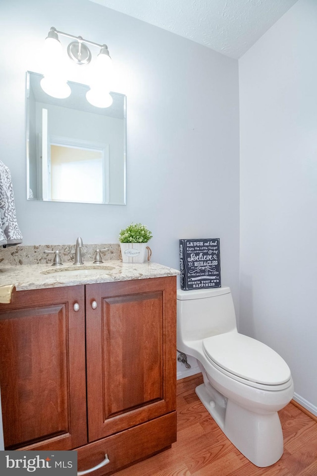 3713 Parkhurst Way, Baltimore, MD 21236 - half bath featuring wood finished floors, toilet, vanity, and baseboards