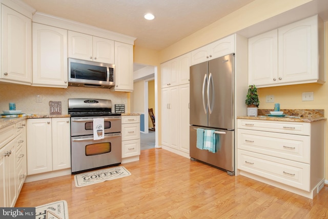 3713 Parkhurst Way, Baltimore, MD 21236 - kitchen with appliances with stainless steel finishes, recessed lighting, light stone countertops, light wood-style flooring, and white cabinetry