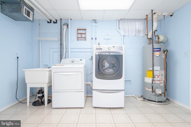 3713 Parkhurst Way, Baltimore, MD 21236 - laundry area featuring water heater, independent washer and dryer, concrete block wall, tile patterned floors, and baseboards