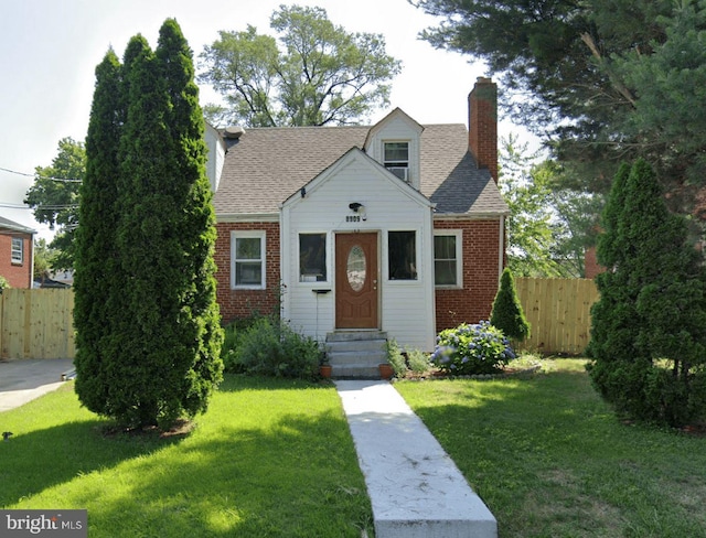 8909 Glenville Rd, Silver Spring, MD 20901 - view of front facade featuring fence, entry steps, a chimney, and a front yard