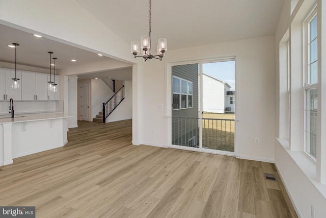 224 Camwood Ct, Fredericksburg, VA 22405 - unfurnished dining area with light wood-style floors, visible vents, vaulted ceiling, and a sink
