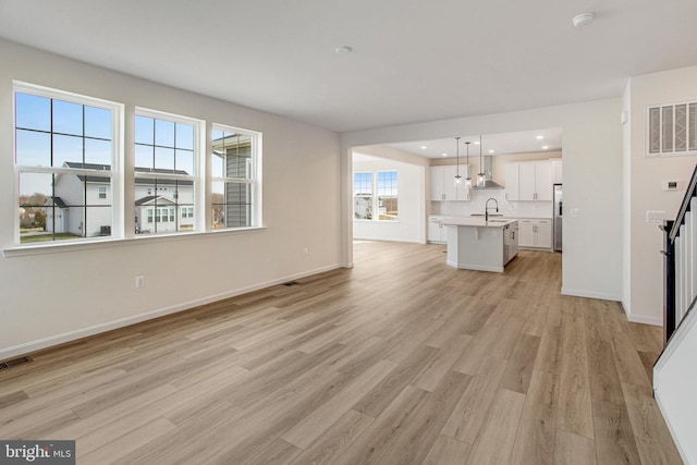 224 Camwood Ct, Fredericksburg, VA 22405 - unfurnished living room with visible vents, baseboards, a sink, recessed lighting, and light wood-style flooring