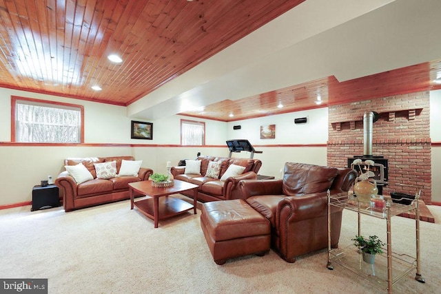 carpeted living room featuring recessed lighting, a wood stove, and wood ceiling