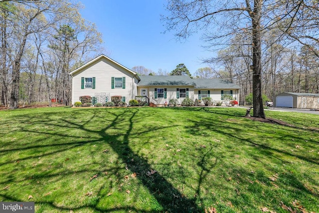 split level home featuring a garage, an outdoor structure, and a front yard
