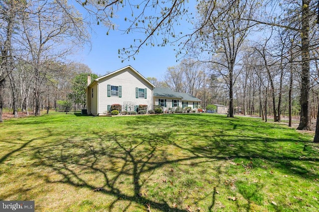 view of front of property with a chimney and a front yard