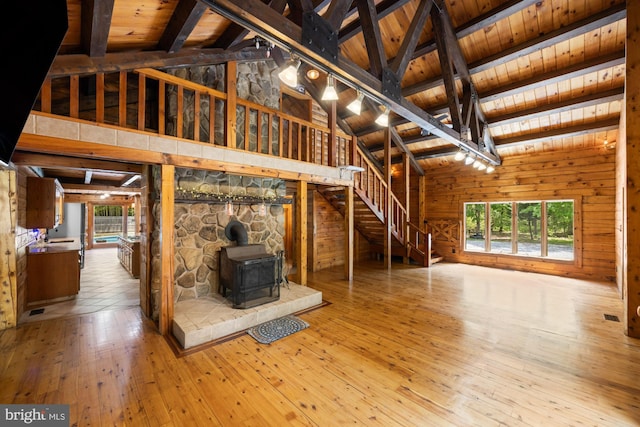 74 Madison Rd, Elmer, NJ 08318 - unfurnished living room featuring wood ceiling with exposed beams, a wood stove, wood-type flooring, wood walls, and high vaulted ceiling