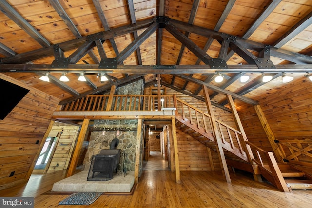 74 Madison Rd, Elmer, NJ 08318 - unfurnished living room with a wood stove, lofted ceiling, hardwood / wood-style flooring, wood walls, and wooden ceiling